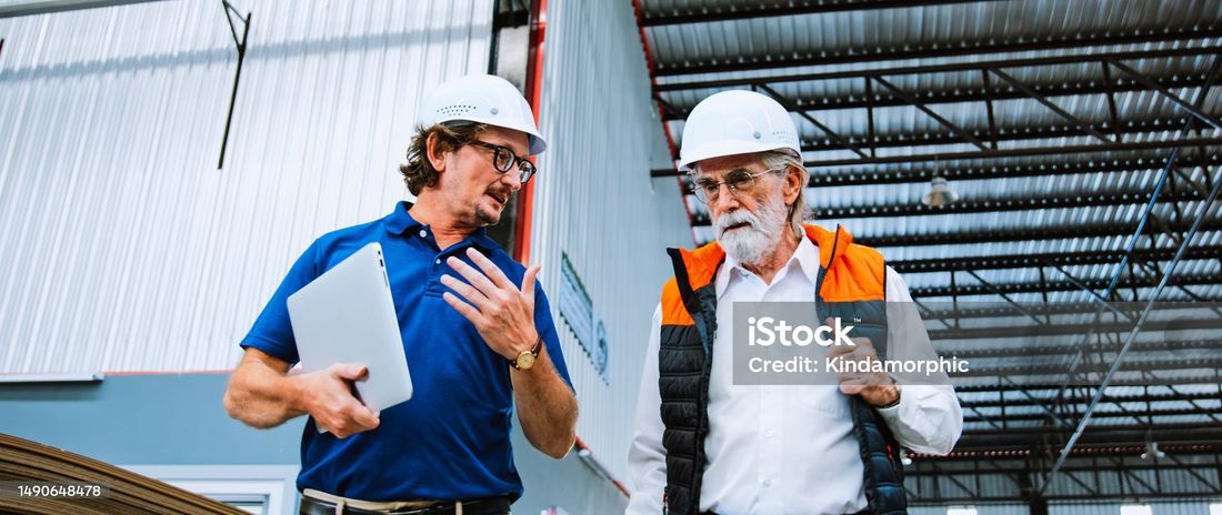 Hawkins-Weir team consulting with a client on an active job site