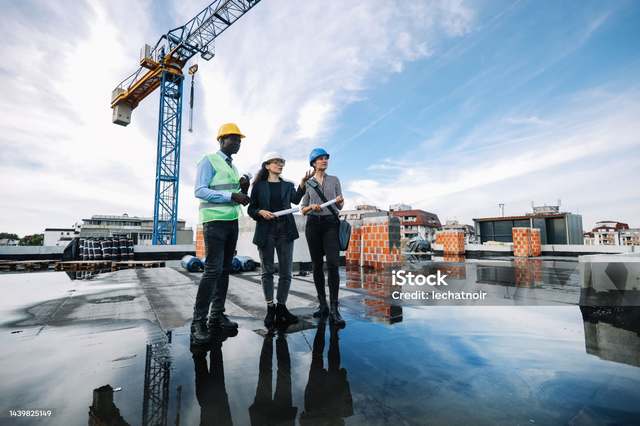 Hawkins-Weir engineer reviewing plans with a client on site